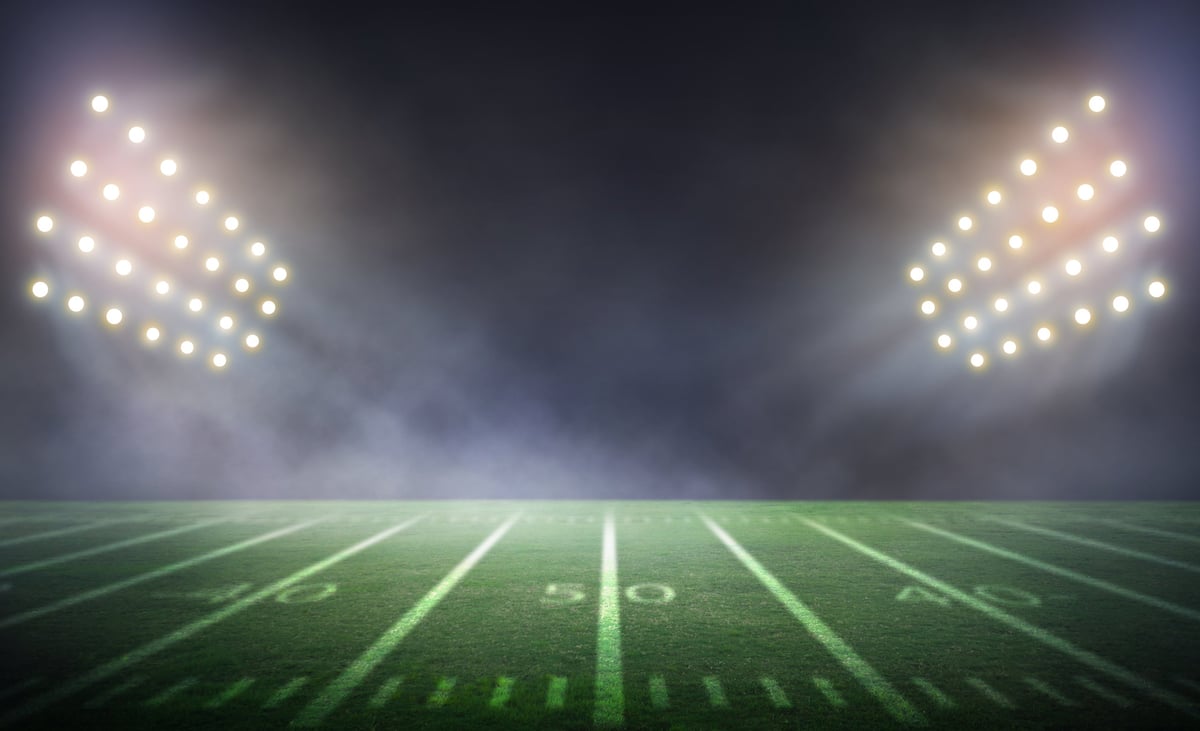 A rendered football stadium under lights